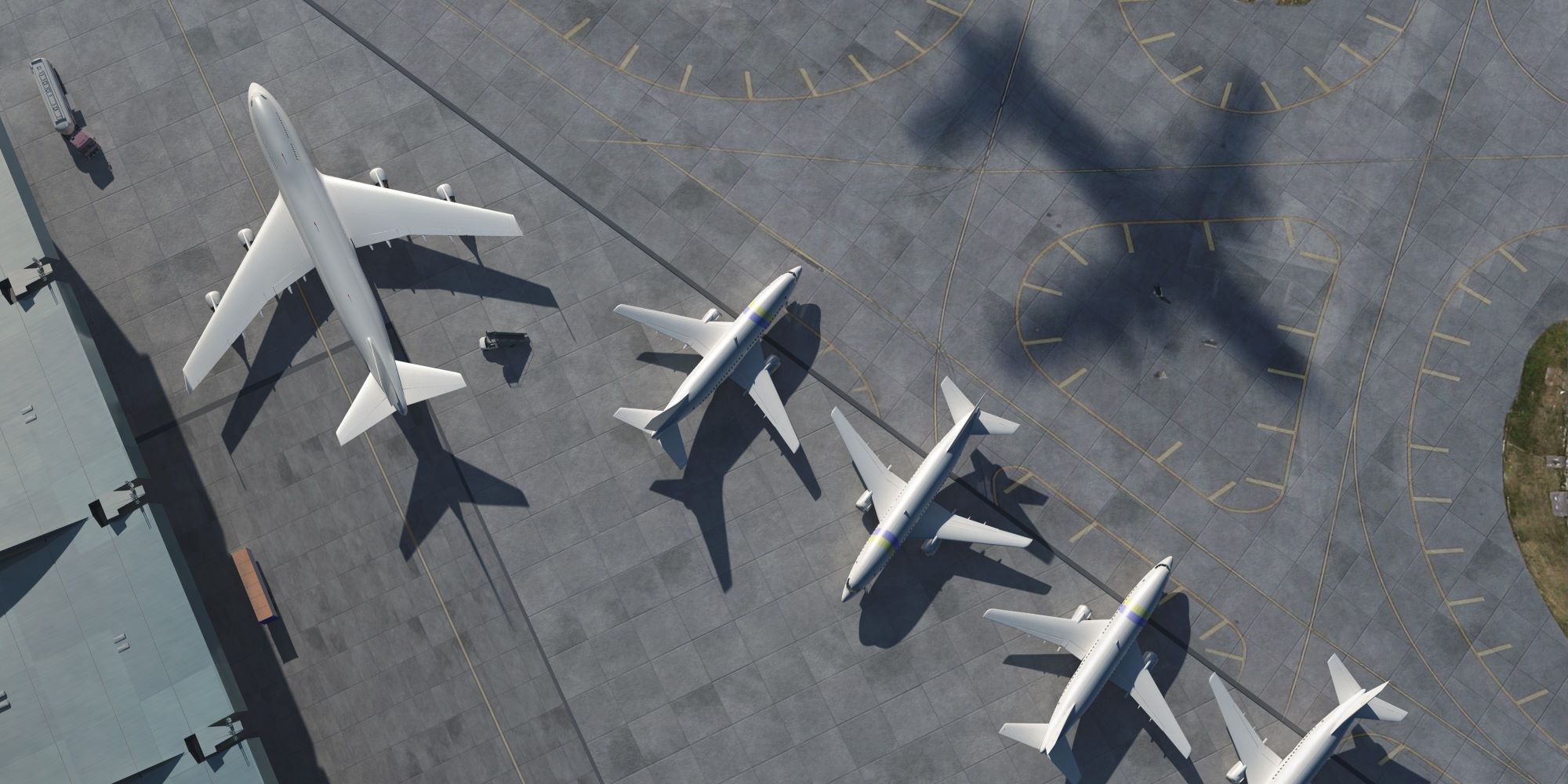 Aerial view of a large airplane and four smaller airplanes, all stationary